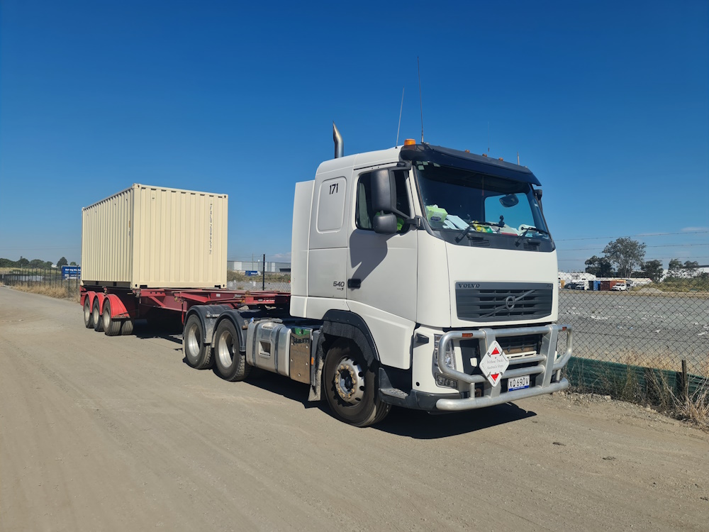 A truck holding a shipping container